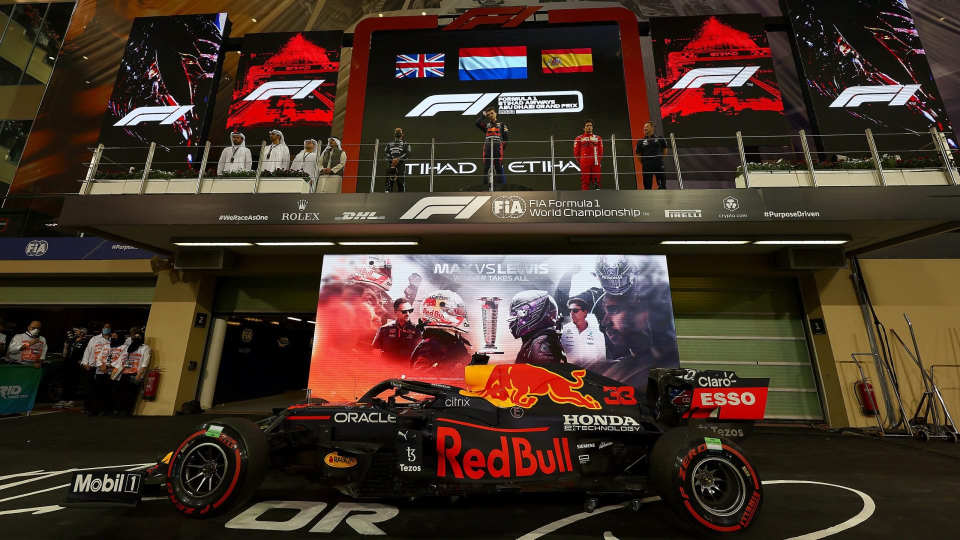 ABU DHABI, UNITED ARAB EMIRATES - DECEMBER 12: Race winner and 2021 F1 World Drivers Champion Max Verstappen of Netherlands and Red Bull Racing celebrates on the podium with second placed Lewis Hamilton of Great Britain and Mercedes GP, third placed Carlos Sainz of Spain and Ferrari and Red Bull Racing Team Principal Christian Horner during the F1 Grand Prix of Abu Dhabi at Yas Marina Circuit on December 12, 2021 in Abu Dhabi, United Arab Emirates. (Photo by Mark Thompson/Getty Images) // Getty Images / Red Bull Content Pool  // SI202112120281 // Usage for editorial use only //
