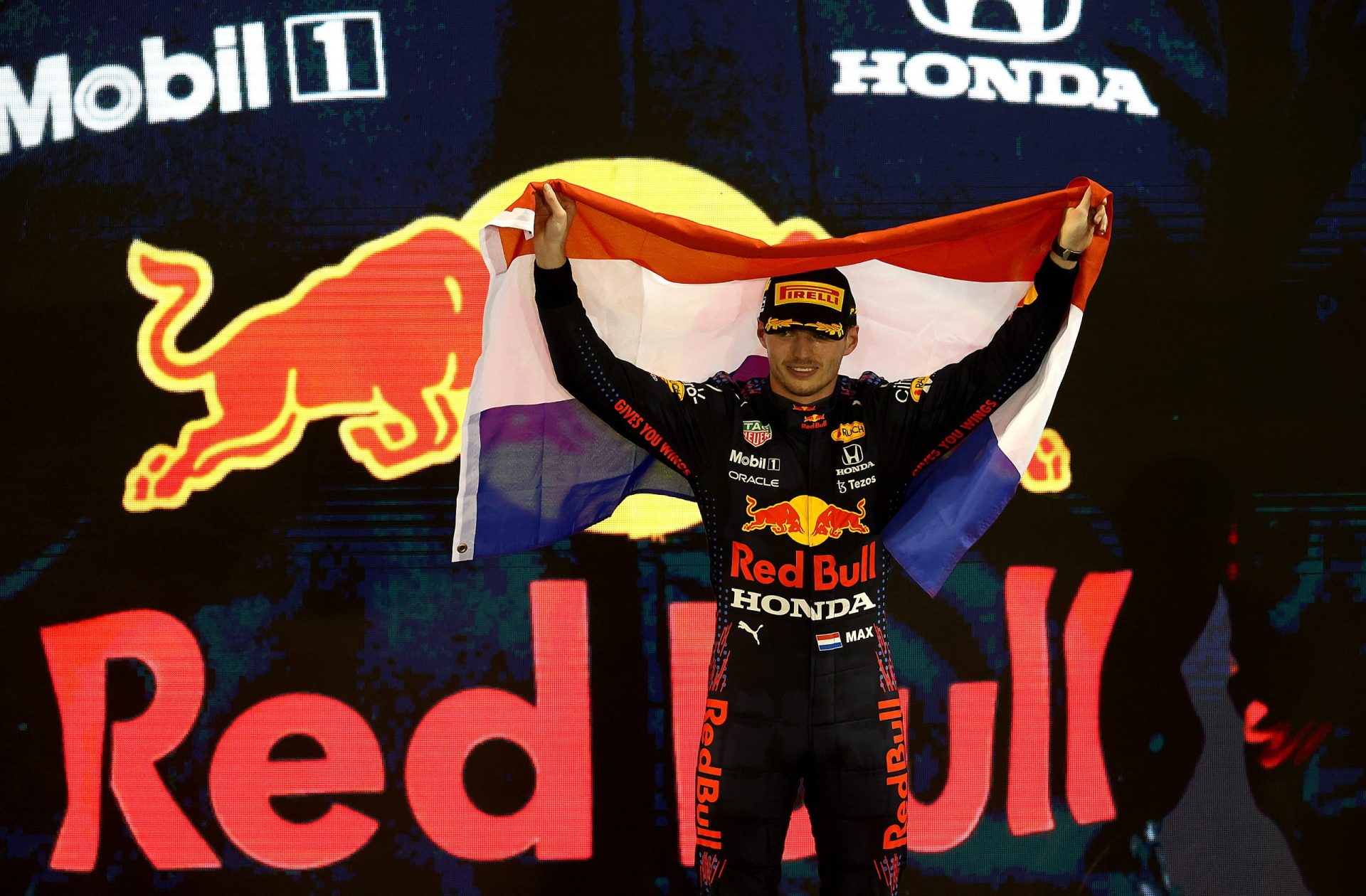 ABU DHABI, UNITED ARAB EMIRATES - DECEMBER 12: Race winner and 2021 F1 World Drivers Champion Max Verstappen of Netherlands and Red Bull Racing celebrates on the podium during the F1 Grand Prix of Abu Dhabi at Yas Marina Circuit on December 12, 2021 in Abu Dhabi, United Arab Emirates. (Photo by Clive Rose/Getty Images) // Getty Images / Red Bull Content Pool  // SI202112120358 // Usage for editorial use only //